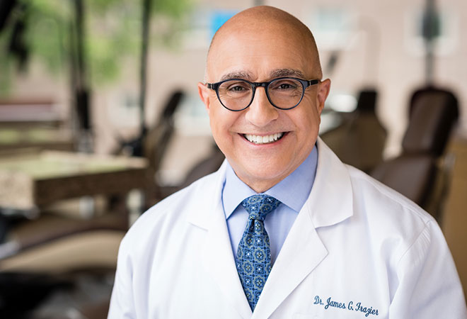 Dr. James Frazier standing with a patient smiling